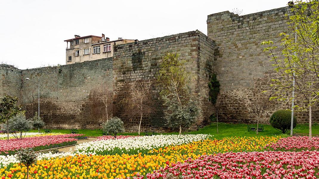 Bright flower beds near ancient walls